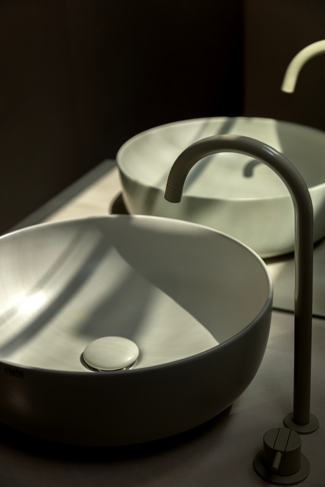 Basin and faucet reflected in a mirror at OXfield